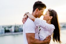 Couple in white hugging each other