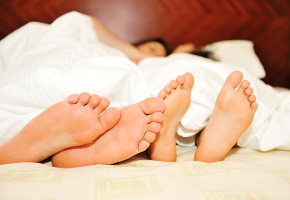 Couple's feet whilst in bed